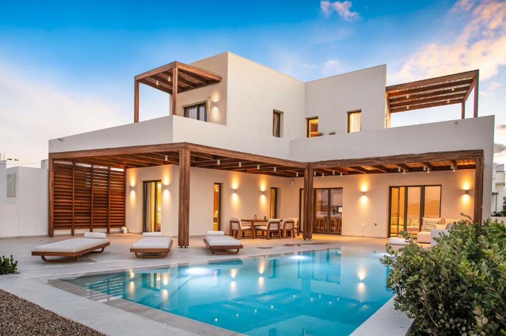 a house with a swimming pool in front of it at Dawn Milos in Pollonia
