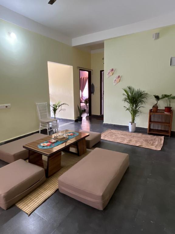 a living room with couches and a table at inoru house in Khairāni