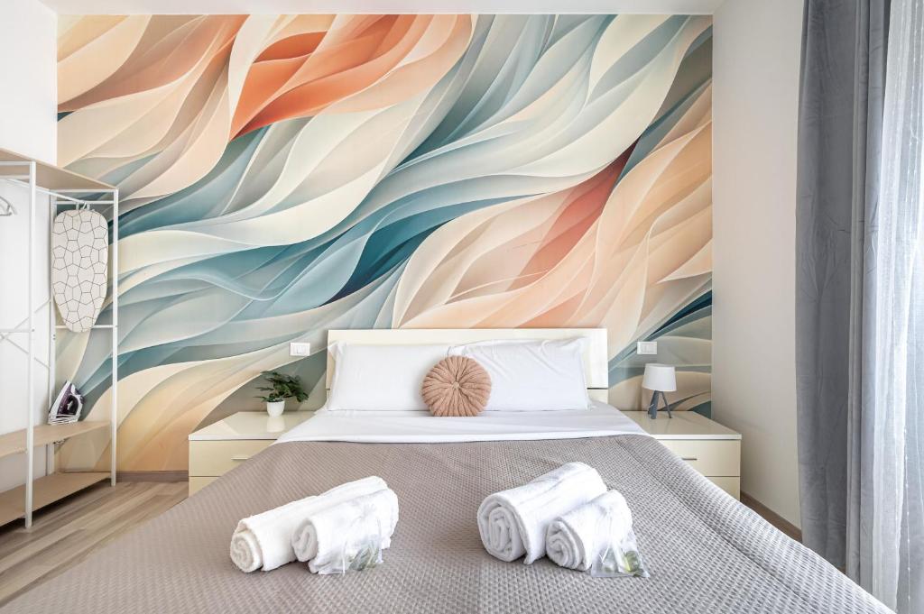 a bedroom with a colorful mural on the wall at Da Vinci Suite Modern Rooms near Metro Basilica San Paolo in Rome