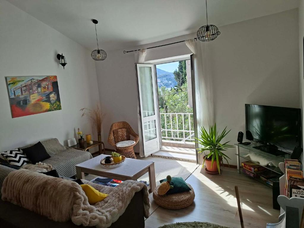 a living room with a couch and a tv at Peaceful retreat beach in Zaton