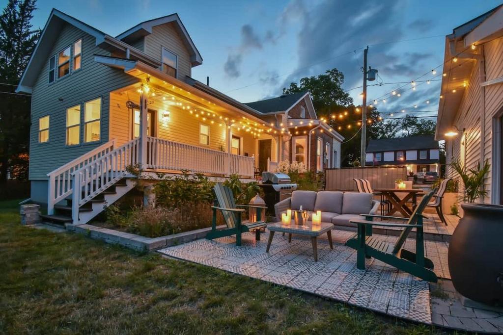 a house with a patio with a couch and a table at The Smith - Renovated 4 Bedroom in Bloomfield