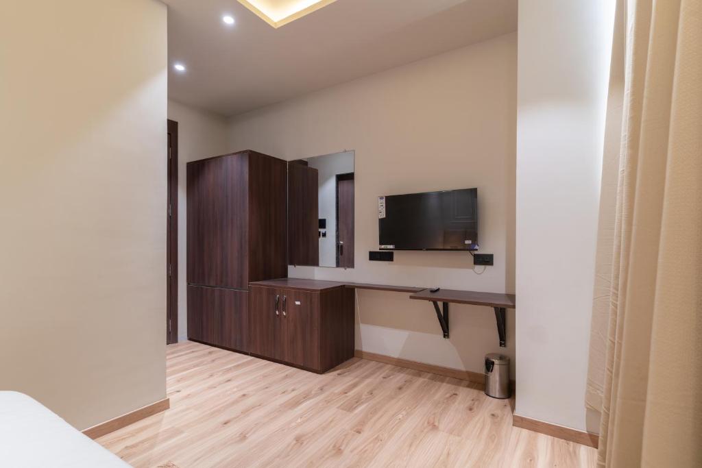 a room with a desk and a television in it at The Grand Dularia in Nagpur