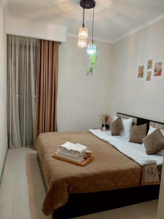 a bedroom with two beds and a chandelier at Alvina House in Tsaghkadzor