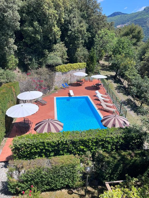 an outdoor swimming pool with umbrellas and lounge chairs at Il Casalino in Maratea