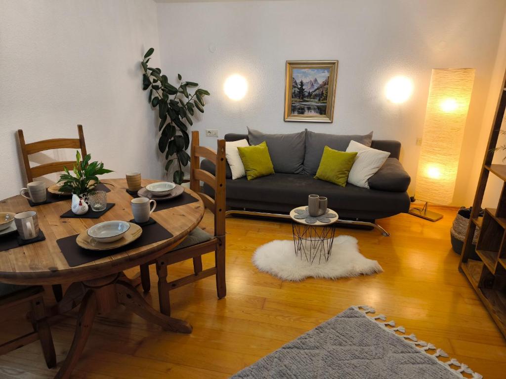a living room with a couch and a table at Ferienwohnung Gabriel in Bad Kohlgrub