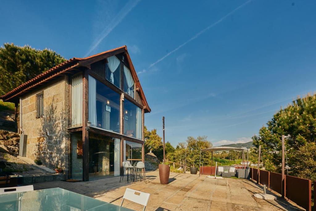 a house with a pool in front of it at Miragem do Douro in Marco de Canaveses