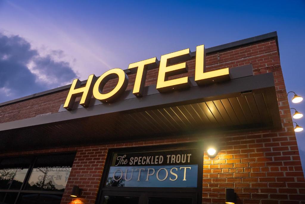 a hotel sign on top of a brick building at The Speckled Trout Outpost in Damascus