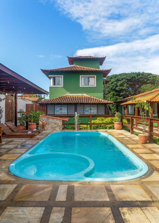 ein Swimmingpool vor einem Haus in der Unterkunft Villa Arpoador | Praia Piscina Churrasqueira Estacionamento | By Buzios Rentals in Costa