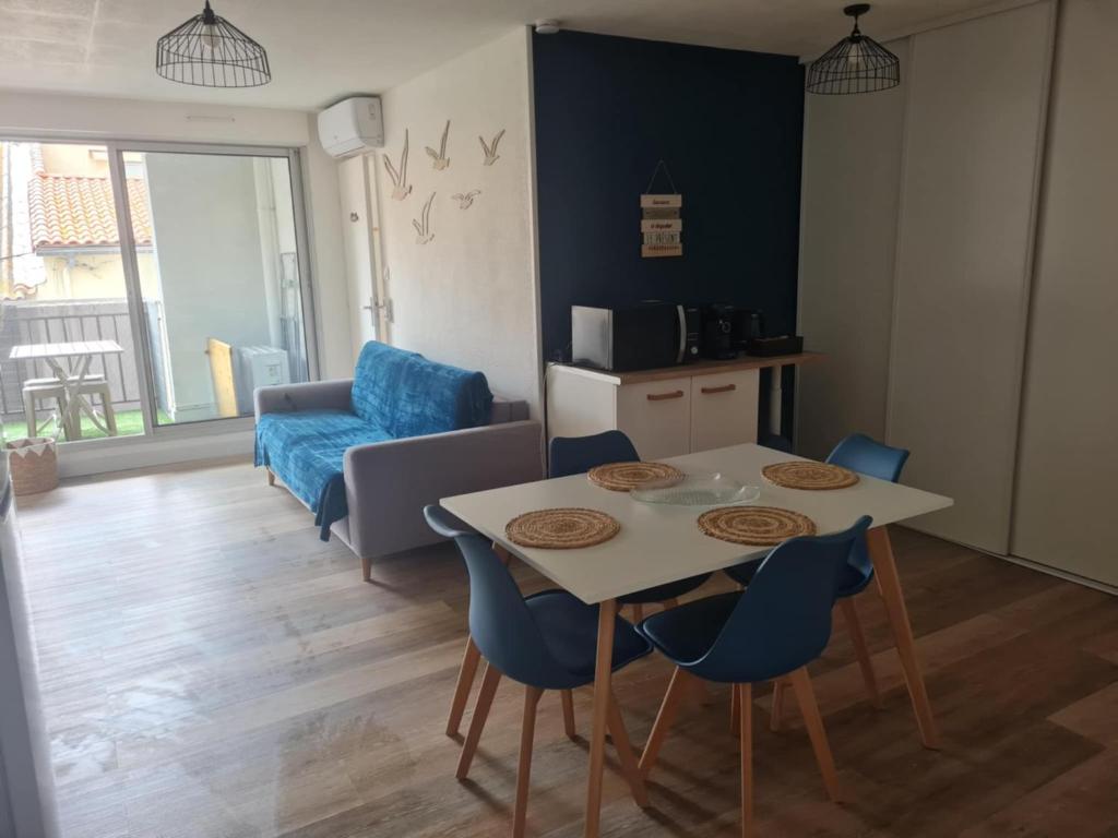 a kitchen and living room with a table and chairs at Le cocon Sétois - T2 et garage privé in Sète