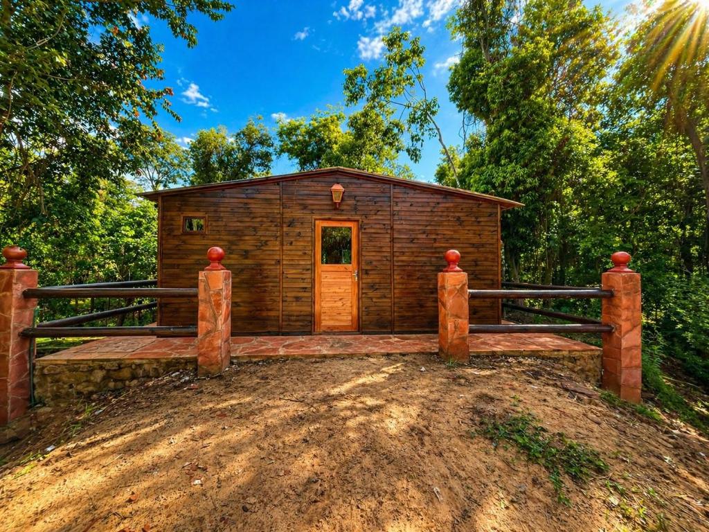 a small log cabin with a fence in front of it at Campo Eden in Capitán Miranda
