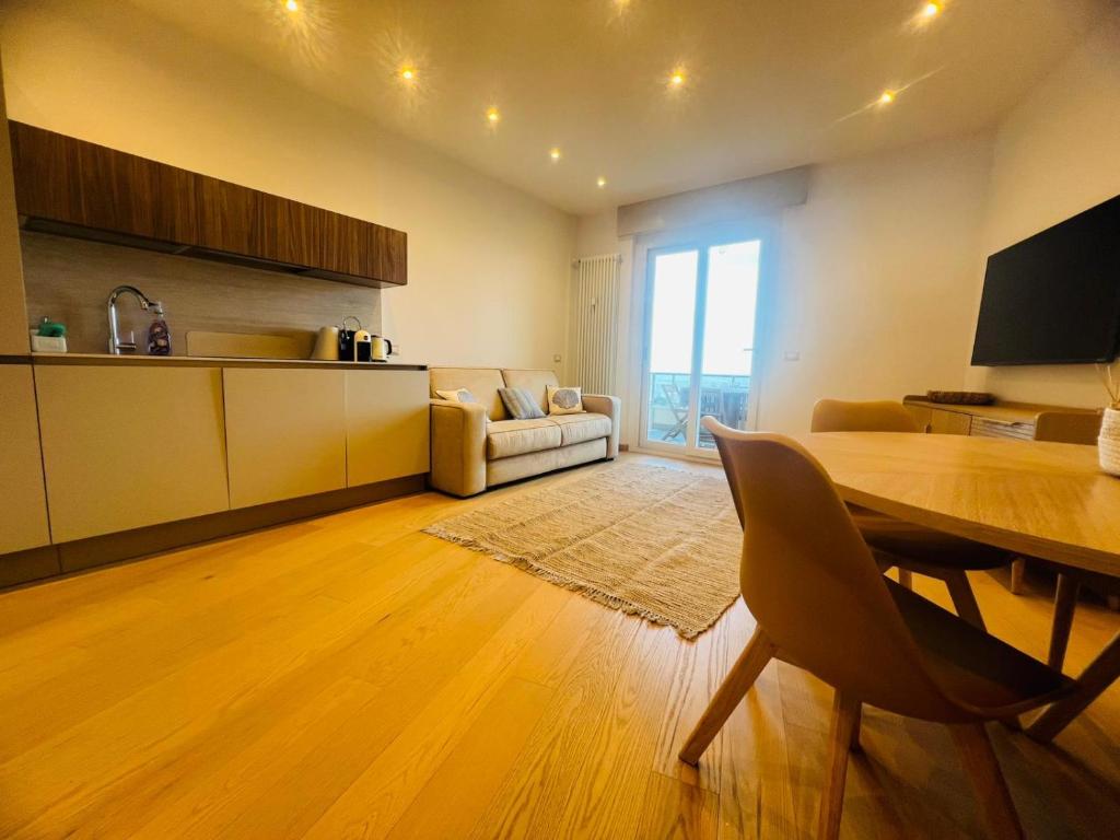 a kitchen and living room with a table and chairs at Suite Luxury Seaview - Sanremo in Sanremo