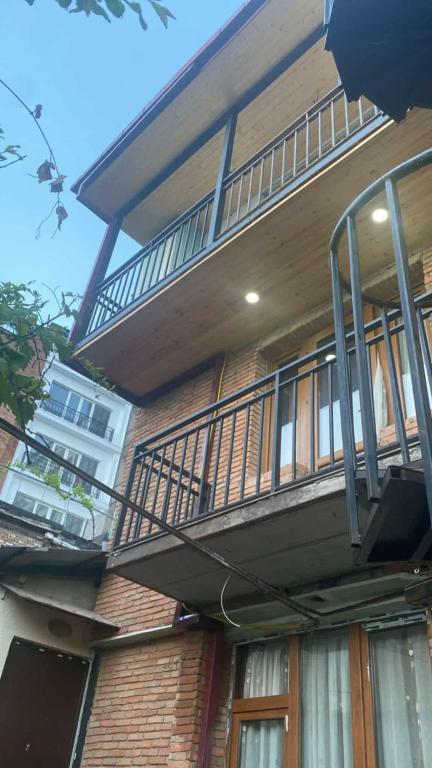 a balcony on the side of a brick building at Avtandili's Apartments in Pʼonichala
