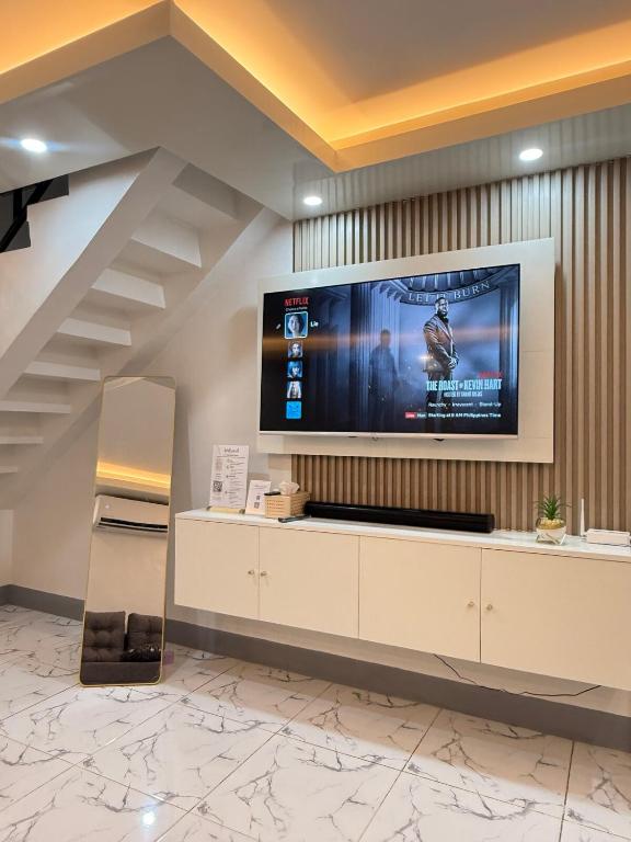 a large flat screen tv on a wall in a lobby at A&F Transient House in San Felipe