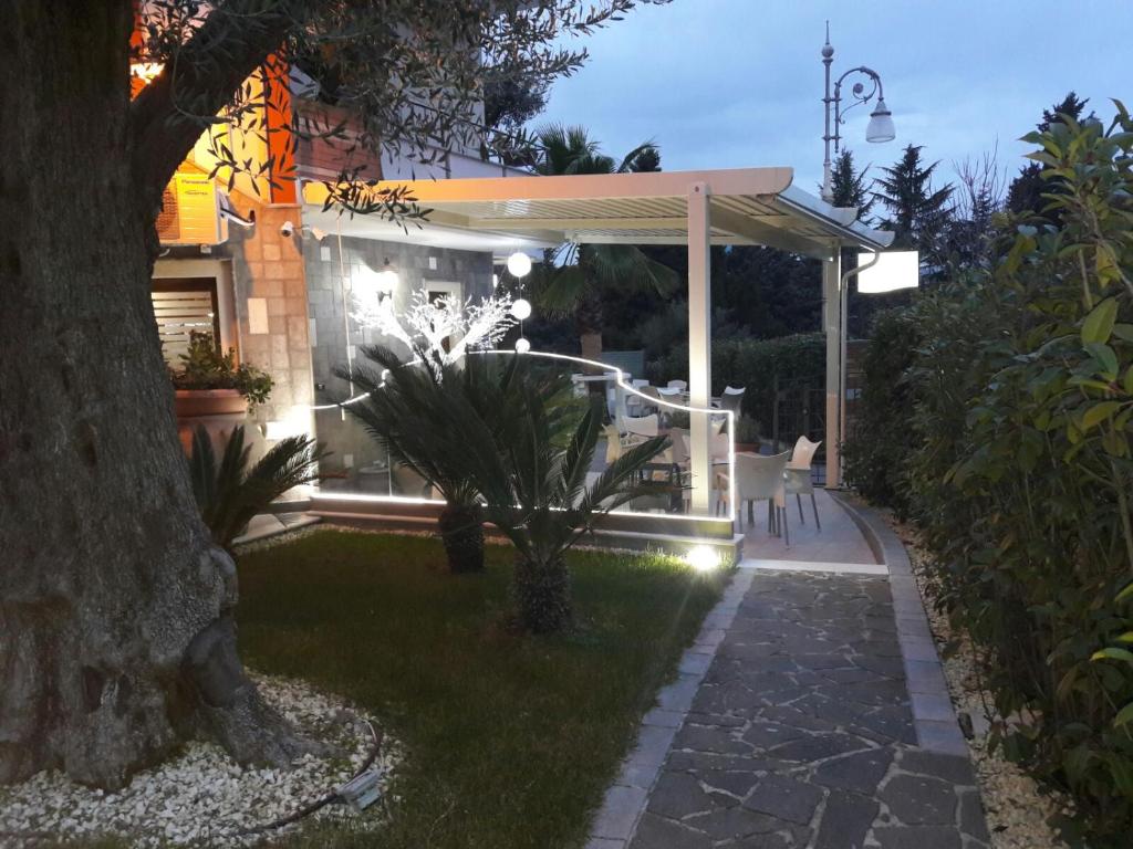 a backyard at night with a gazebo at Hotel Sirio in Rotonda