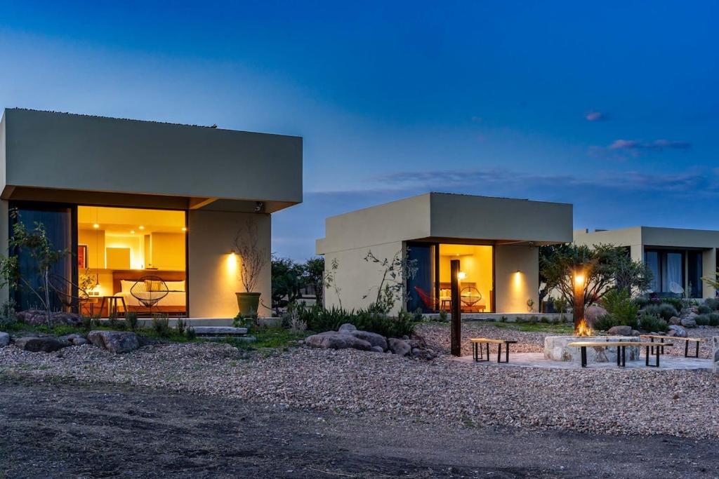 a house with lights on in front of it at Villa Lua, 2BR Countryside Bungalows for 6 Guests in La Talega