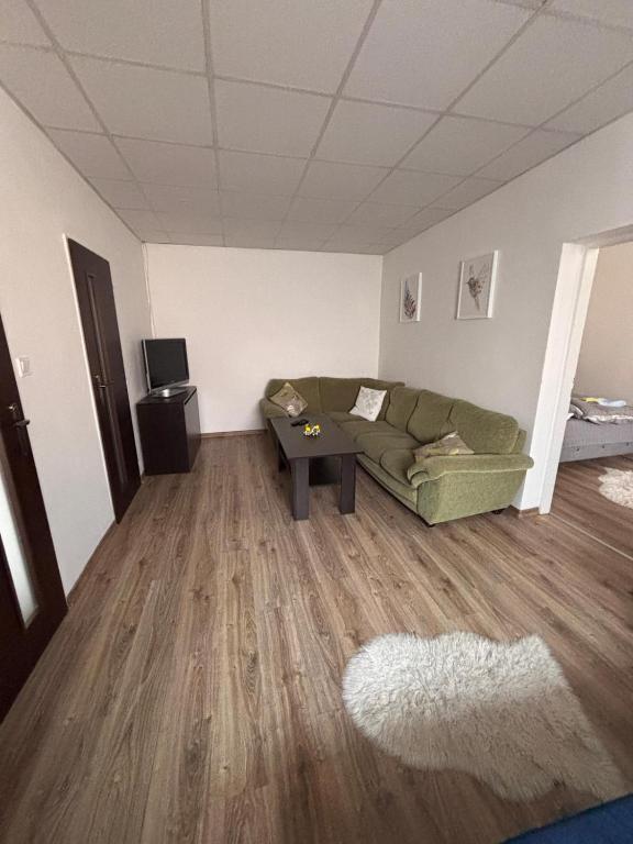 a living room with a couch and a table at Cozy place in Stará Ľubovňa