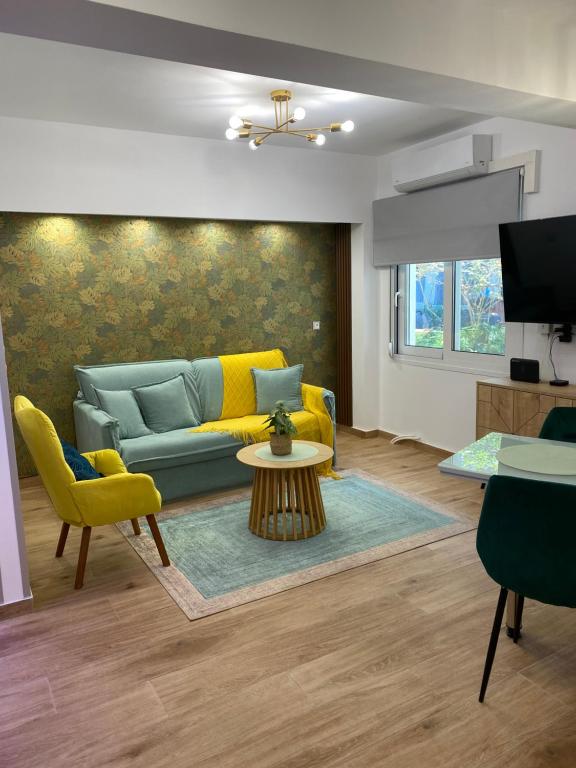 a living room with a couch and a table at Urban Garden Suite-Samos Center in Samos