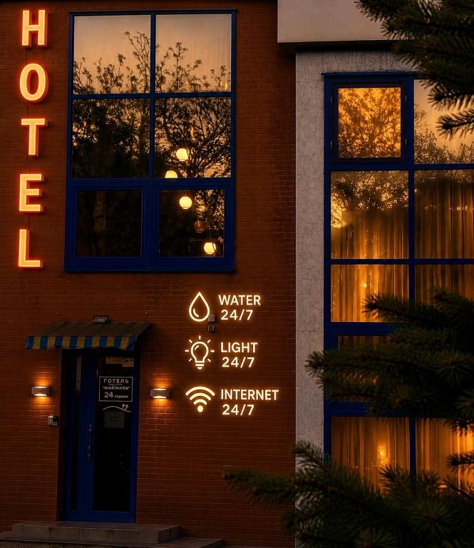 a sign on the side of a building with a window at Hotel Marinara in Odesa
