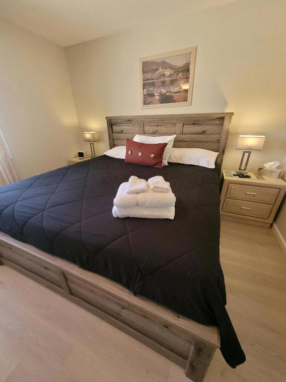 a bedroom with a large bed with towels on it at CASA Allegro - Active Vacationers Paradise in Sun City West