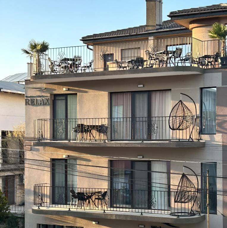 a building with tables and chairs on the balconies at Relax Boutique House in Kranevo