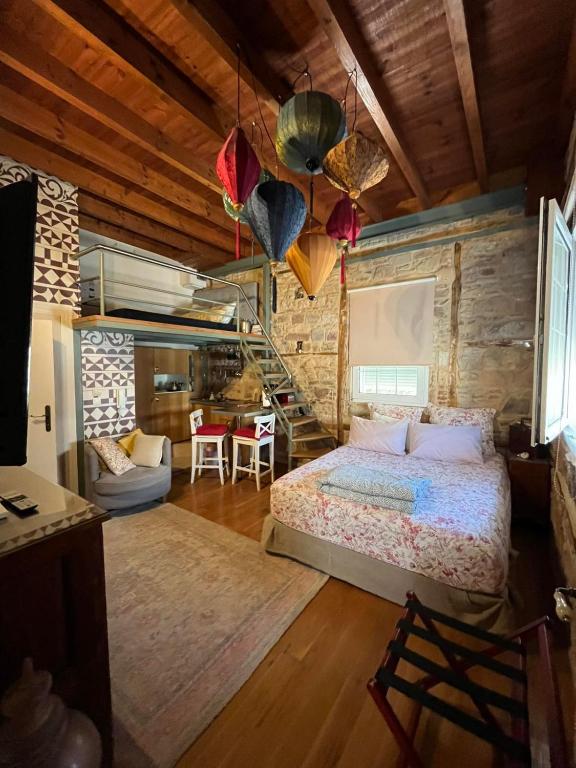 a bedroom with a bed and a staircase in a room at Homeric Poems in Chios