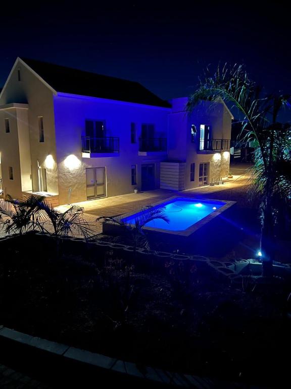a house with a swimming pool at night at Vue de Valleé in Wellington