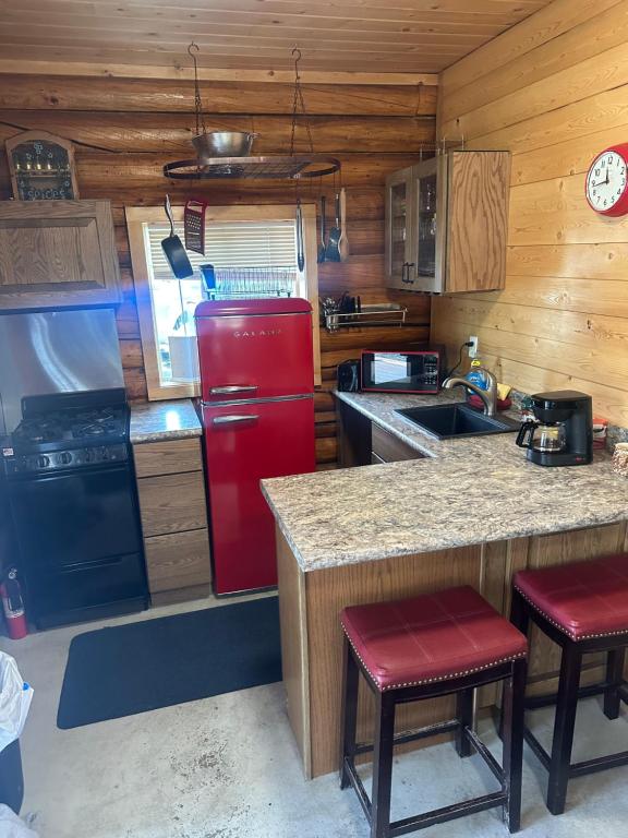 a kitchen with a red refrigerator and a counter at Modern studio Cabin in Tok