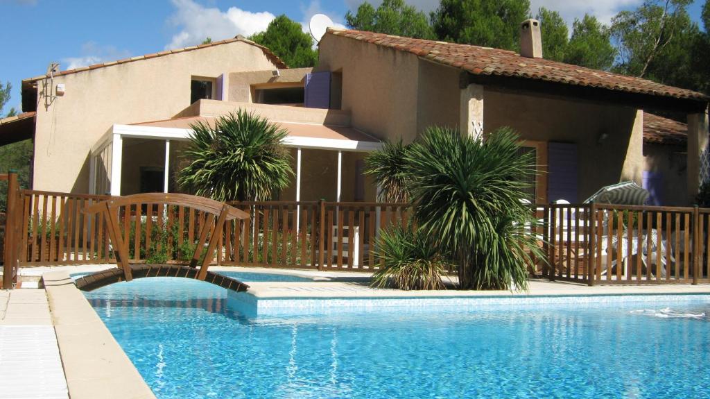 a house with a swimming pool in front of a house at Gites Croignes-Ponant in Lambesc