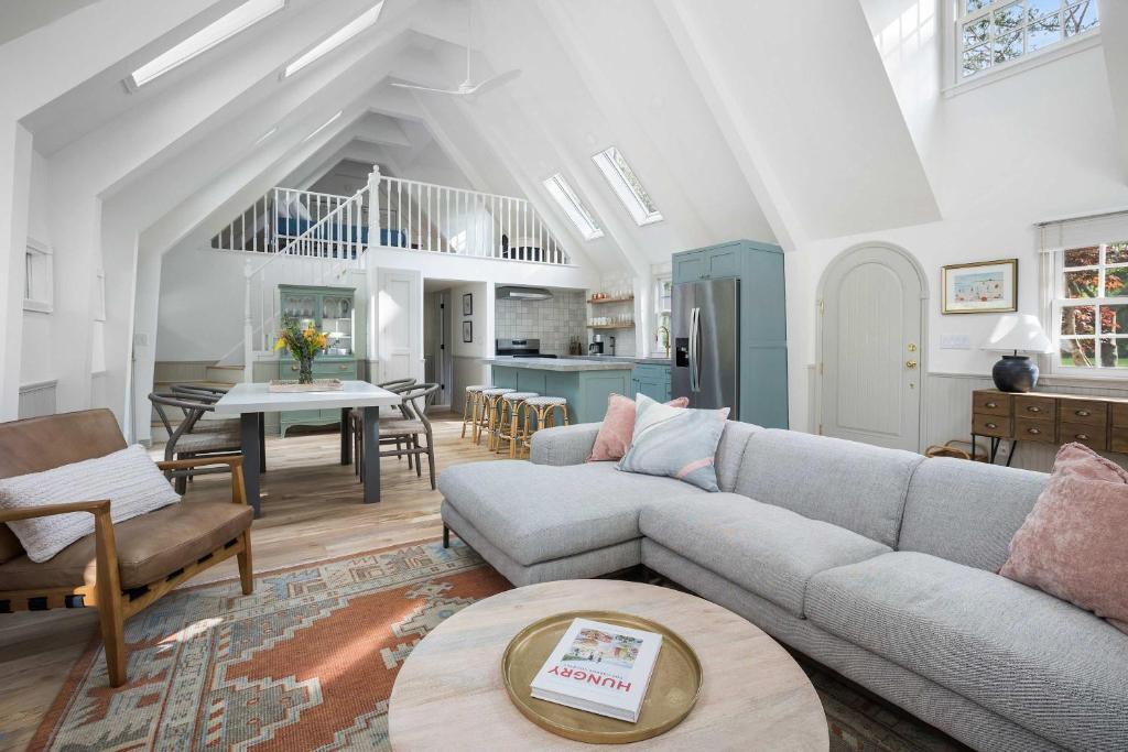 a living room with a couch and a table at The Songbird by Juniper Holiday + Home in New Buffalo