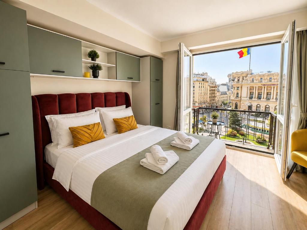 a bedroom with a large bed and a large window at Victoriei Studio Old City in Bucharest