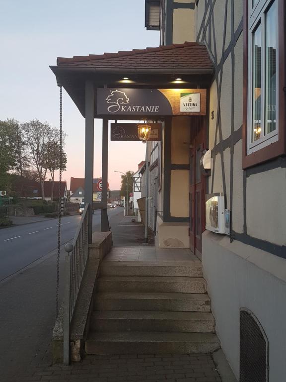 a building with a sign on the side of a street at Esskastanie - Pension und Restaurant in Twiste