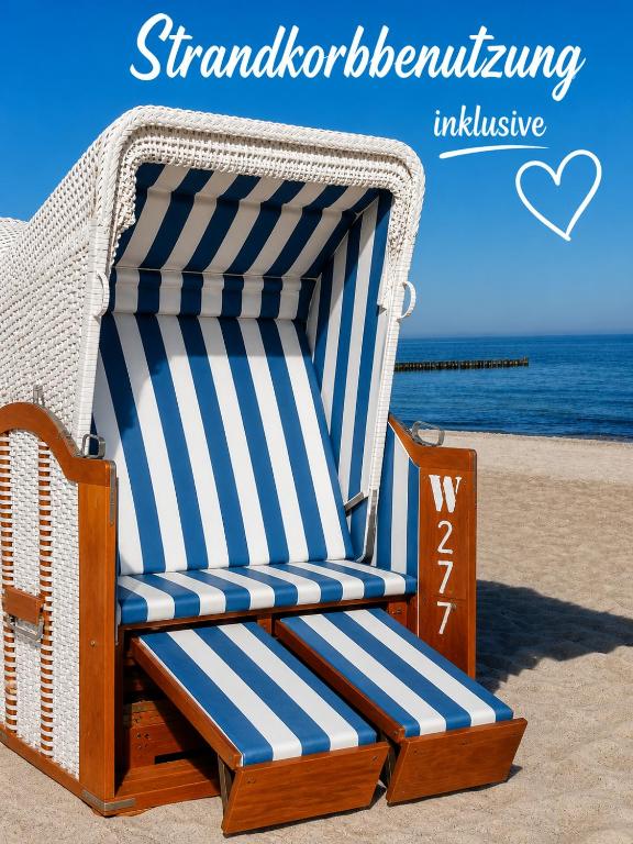 a beach chair sitting on the sand at the beach at Meeresrauschen in Graal-Müritz