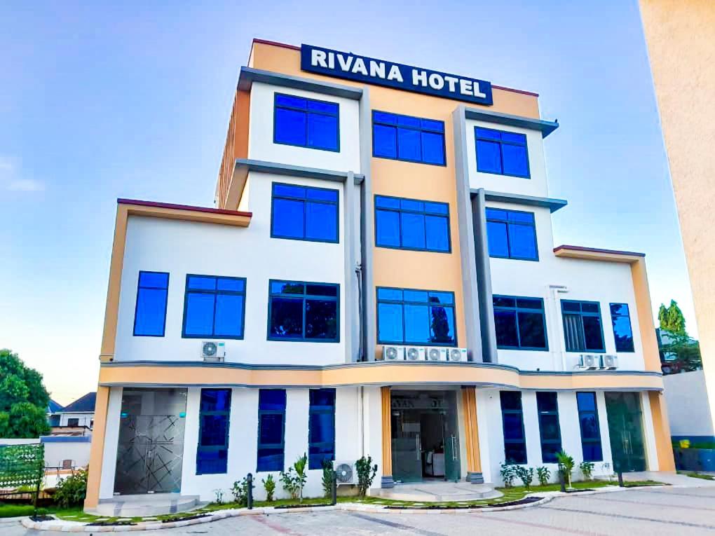 a hotel with a sign on top of it at RIVANA HOTEL Goba in Dar es Salaam