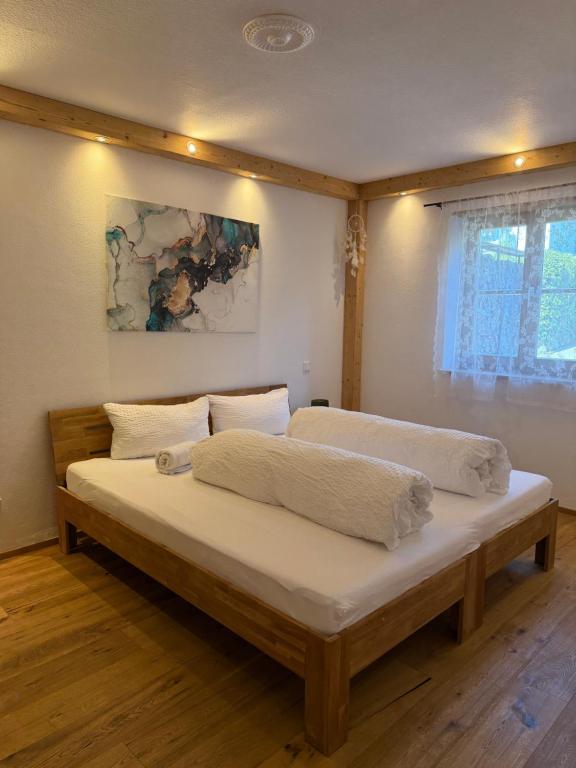 a bedroom with two beds and a painting on the wall at Ferienwohnung Andreas in Holzkirchen