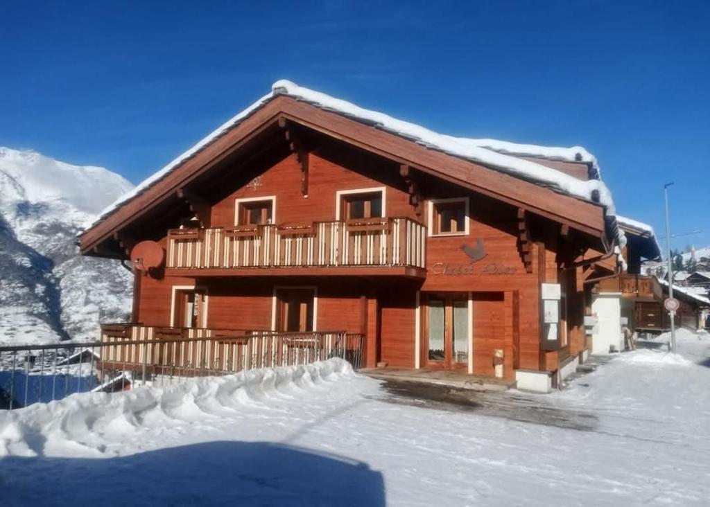 a log cabin in the snow with snow covered at Chalet Adler in Grächen