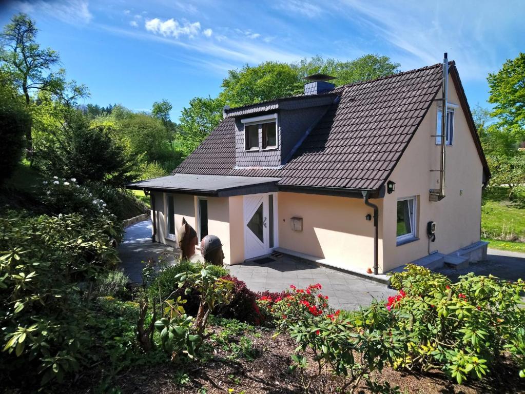 a house with a horse standing in front of it at Ferienhaus Bielefeld in Bielefeld