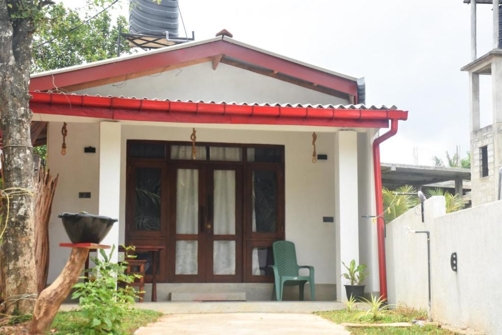 a small house with a red roof at Miu Villa in Ahangama
