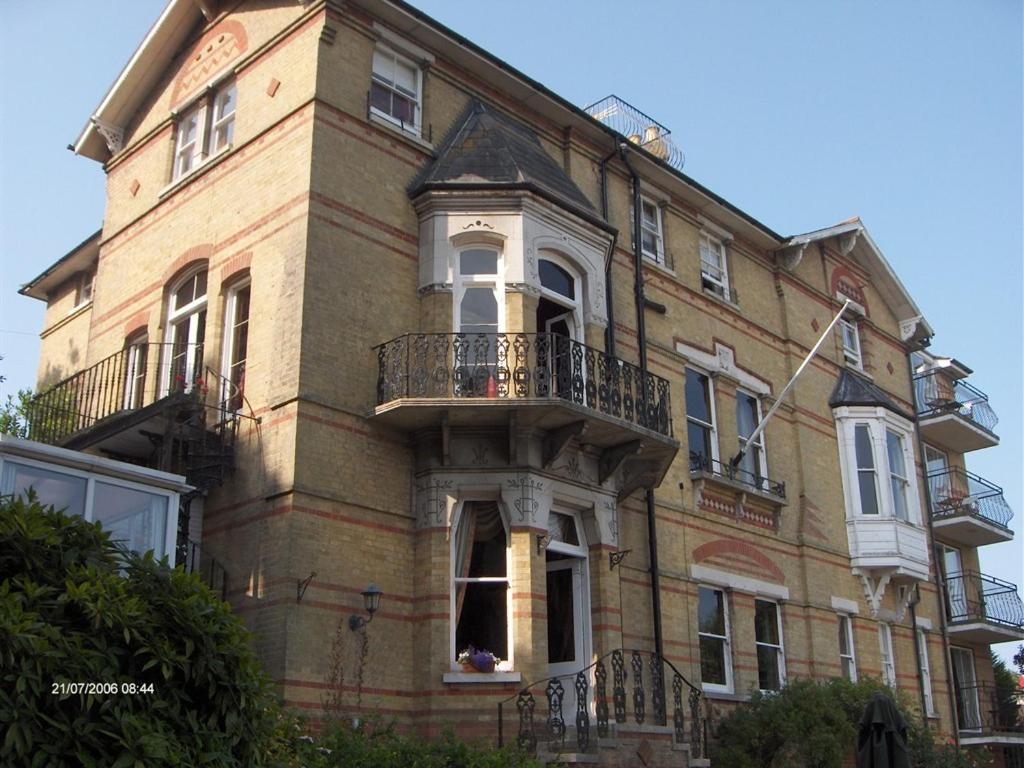 a large brick building with a balcony on the front at Villa Rothsay Hotel in Cowes