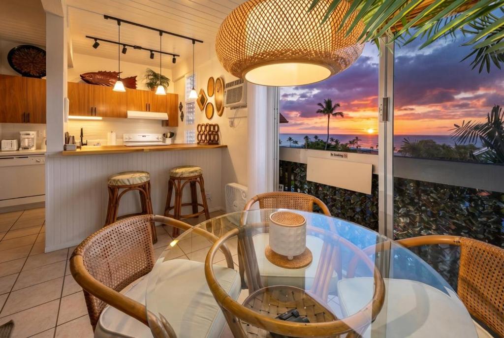 a dining room and kitchen with a view of the ocean at Kona Mansions#B217 Beautiful unit with Ocean view! in Kailua-Kona