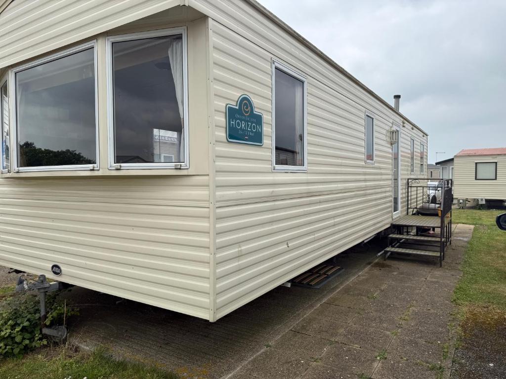 a mobile home with a sign on the side of it at Holiday Caravan Orchards Holiday Village in Brightlingsea