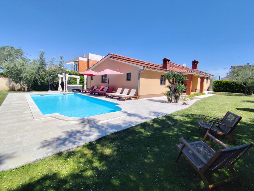 a house with a swimming pool in a yard at Villa Tramonto 4 stars, Krnica in Krnica