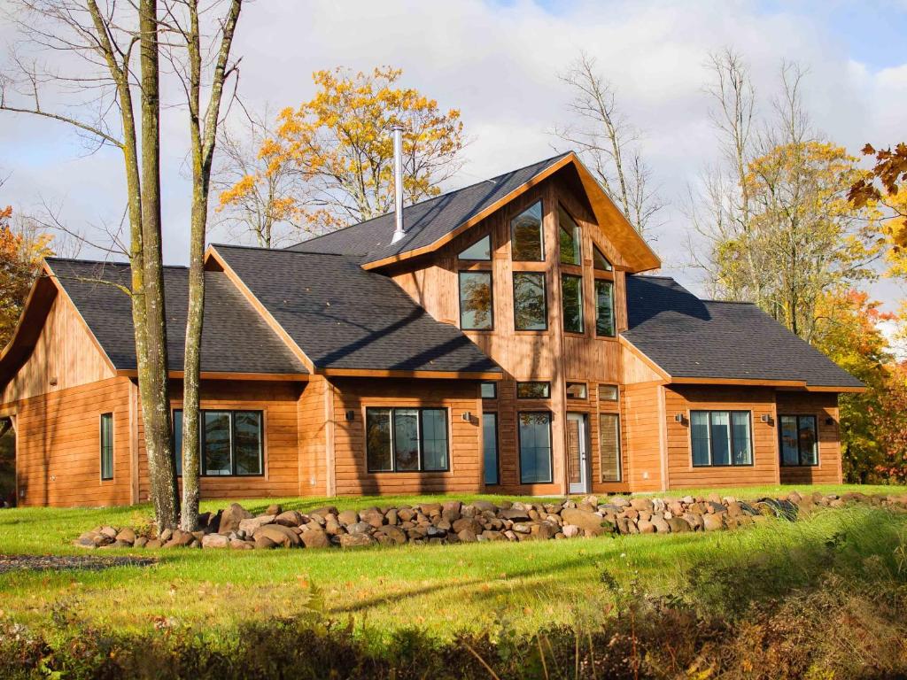 a wooden house with a black roof at Timber Baron Inn in Bayfield