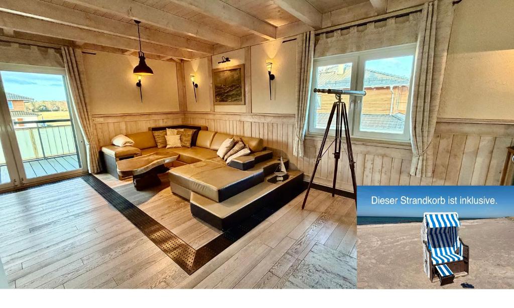 a living room with a couch and a camera at Penthouse Meeresrauschen in Dierhagen