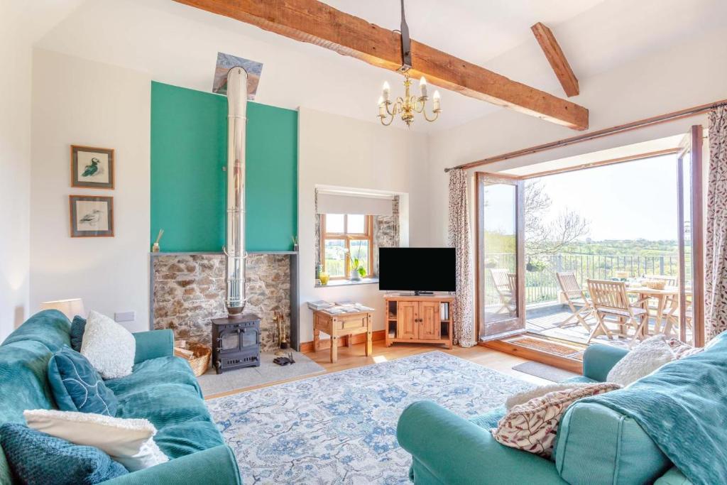 a living room with a blue couch and a tv at 2 Bed in Holsworthy oc-91755 in Holsworthy