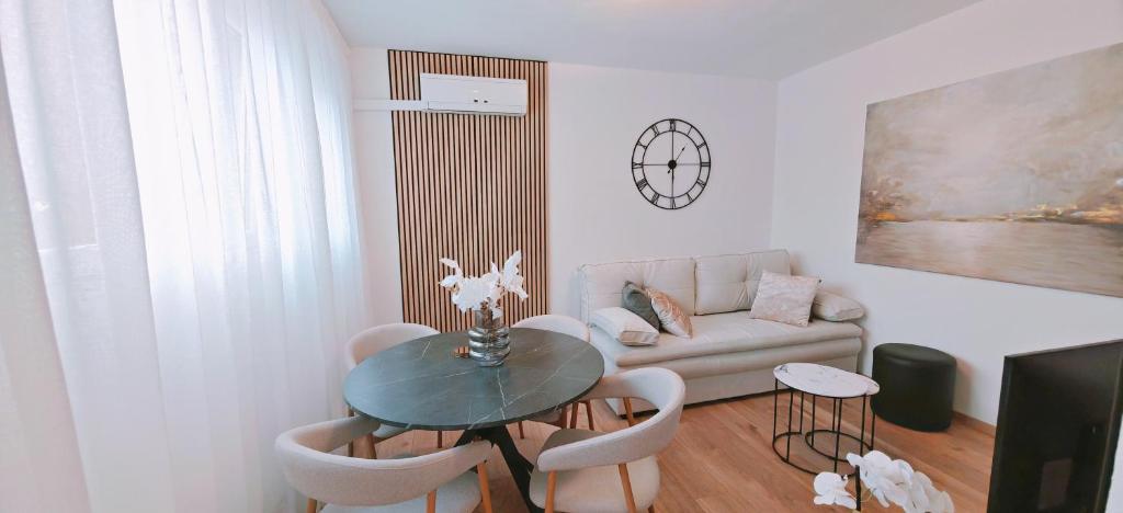 a living room with a table and a couch at Happy Dreams Apartment near the beach and old town in Split
