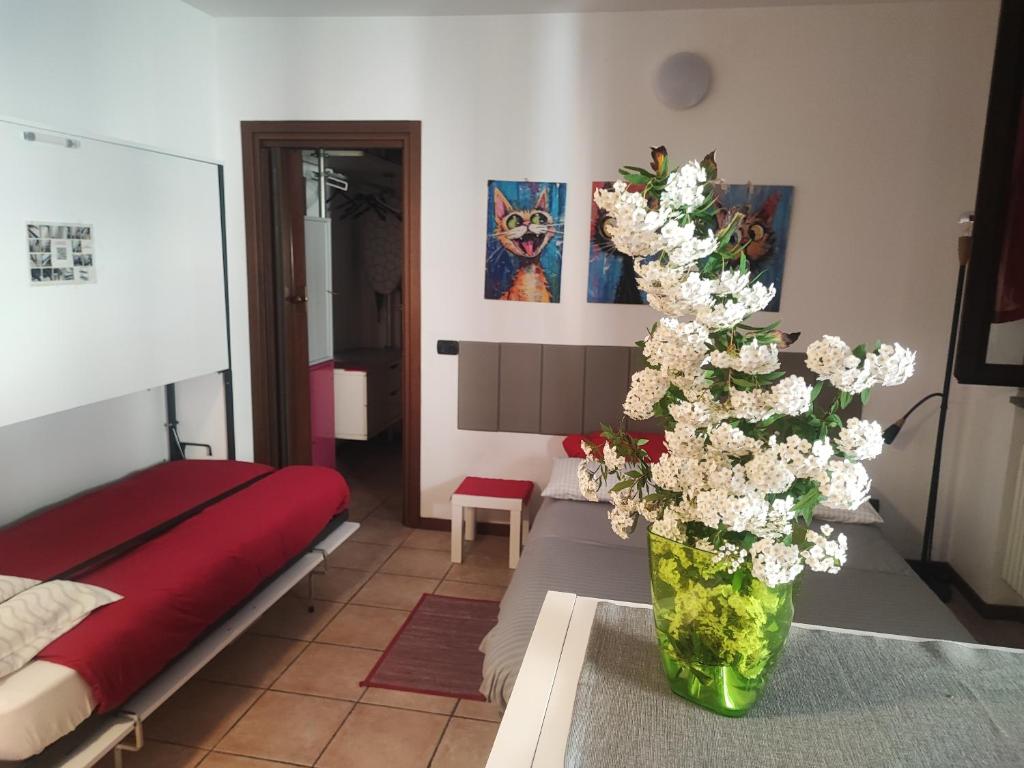 a vase with white flowers on a table in a room at Leo House in Trezzo sullʼAdda