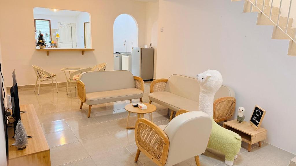 a living room with chairs and a couch and a table at Leisure29 Suites - Setali - 7pax in Kuantan