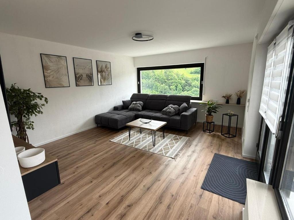 a living room with a couch and a table at Ferienwohnung Bächle in Bad Peterstal