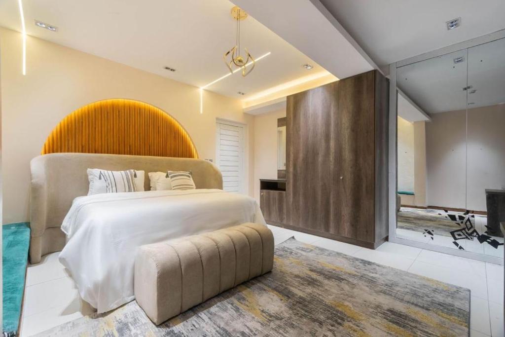 a large bedroom with a large bed and a television at Bridge Apartment Lagos in Lekki