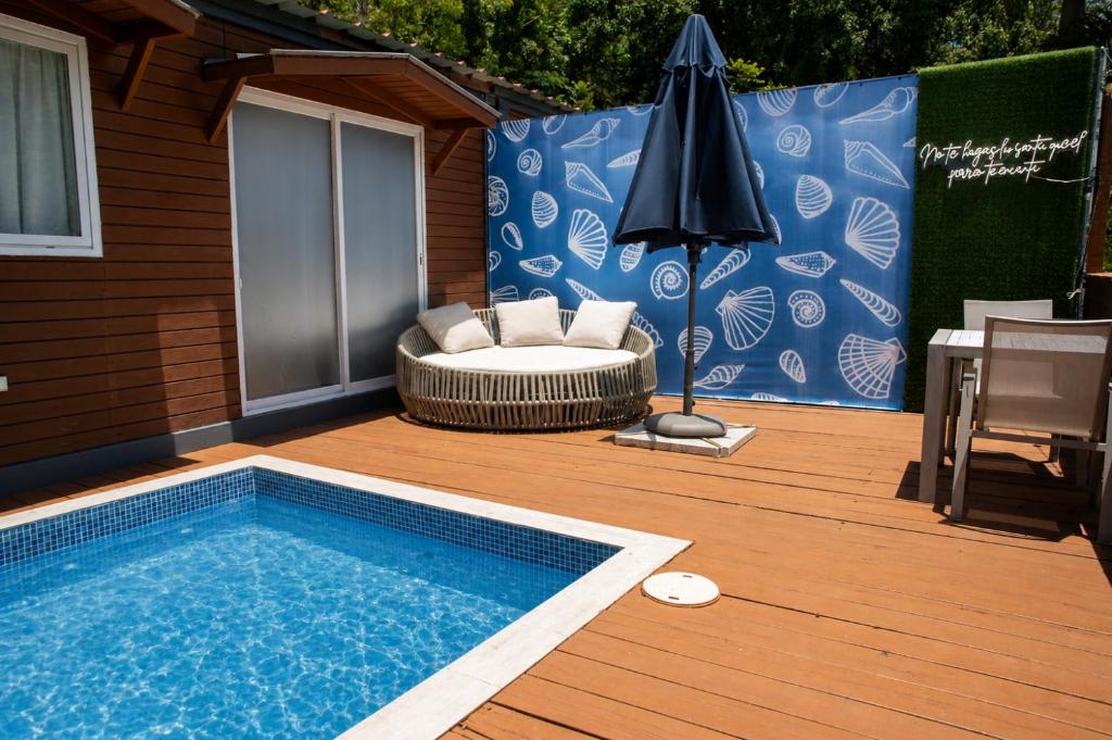 a patio with a swimming pool and an umbrella at La Ceiba Suite 2 with private plunge pool in Anasco